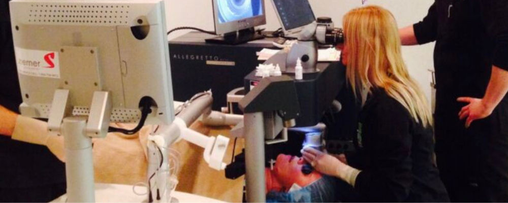 A patient undergoing LASIK eye surgery with a medical professional and laser equipment, illustrating a healthcare influencer partnership in action.