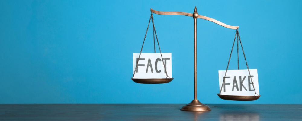 A balance scale on a blue background with "FACT" on one side and "FAKE" tipped higher on the other, illustrating health misinformation